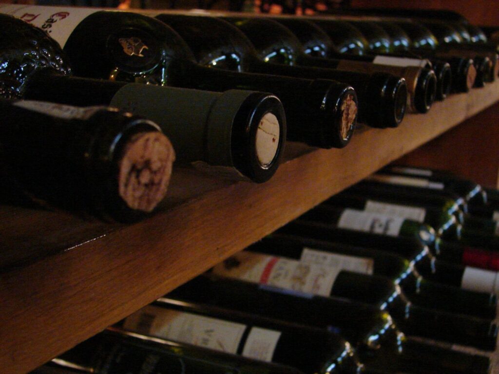 Wine bottles on a rack.